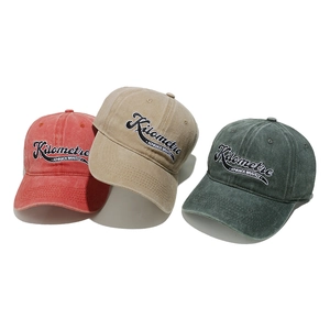 Close-up of vintage washed cotton baseball caps with high-quality letter embroidery