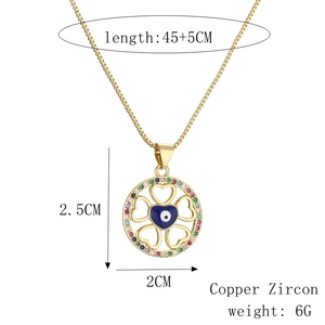 Detail showing clover pendant with blue evil eye and colorful zircon on a gold chain