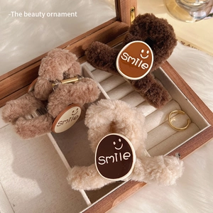Plush smile face claw clips in brown and beige tones for elegant hair styling
