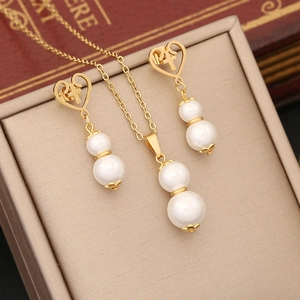 Golden heart necklace and earrings set with double pearls and cross charms