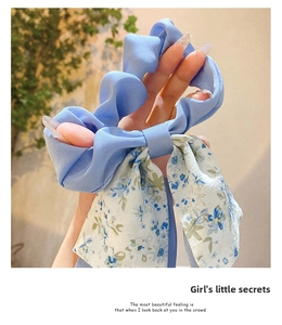 Close-up of blue floral chiffon scrunchie with long ribbon streamers for hair