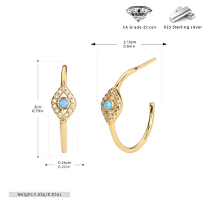 Detail view of gold-plated S925 silver C-shaped earrings with blue opal and zirconia