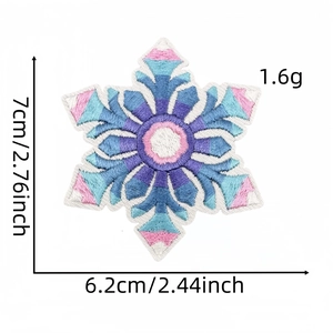 Detail of embroidered snowflake patches with size measurements in pink and blue