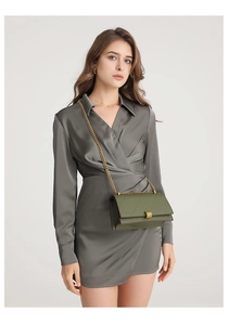 Detailed view of olive green quilted handbag with elegant gold chain and metal buckle
