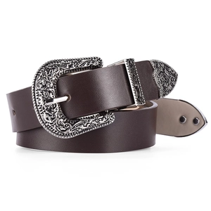 Close-up of Western vintage silver engraved buckle on dark brown leather belt