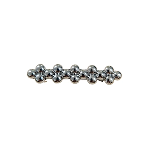 Minimalist silver metal hair clip with a row of polished spherical bead textures