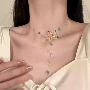 Macro shot of colorful beaded flower necklace with long tassel fringe on collarbone