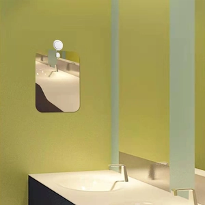Frameless rectangular acrylic bathroom mirror with rounded corners mounted on the wall