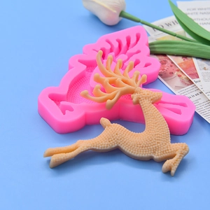 Pink silicone deer mold for Christmas baking with a detailed reindeer cake topper
