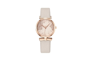 Detail of rose gold watch case with leaf pattern dial and cream leather bow-tie strap