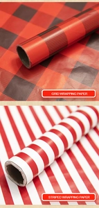 Detail view of red grid and striped Christmas wrapping paper rolls with paper cores