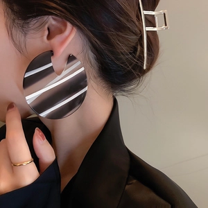Chunky striped acrylic hoop earrings for women with bold black and white pattern