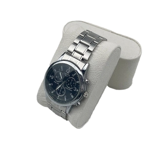 Classic men's silver watch with black dial and three-eye design on a cream cushion