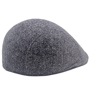 Detail shot of the dark grey herringbone pattern and wool-like texture on the flat cap