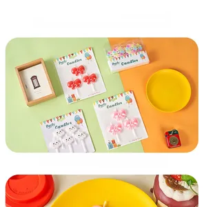 Detail of cute cartoon bow and cloud smokeless candles for birthday cake decoration