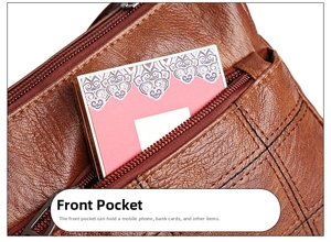 Detailed view of the front pocket of the brown leather bag with a metal zipper