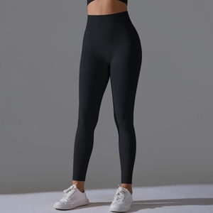 Detail showing seamless high-waist black yoga pants with tummy control compression