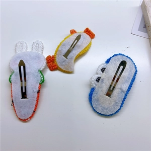 Three cute knitted hair clips for girls including rabbit, duck, and monster designs