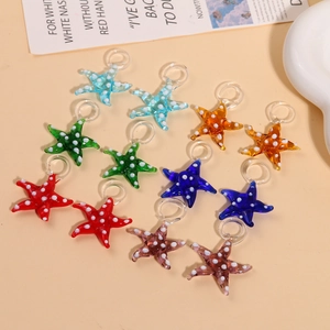 Detailed view of colorful glass starfish pendants with white polka dots for DIY jewelry making