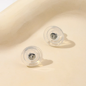 Macro detail of 18K gold and silicone butterfly earring backs for DIY jewelry making