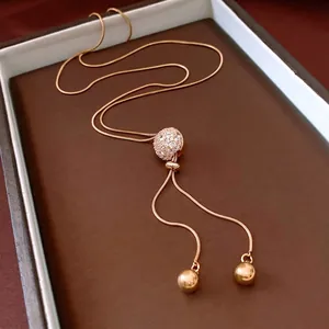 Vintage gold plated snake chain necklace with a pave crystal ball pendant and tassels