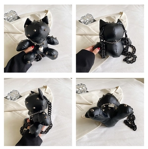 Detail view of punk style black cat crossbody bag with silver rivets and heart charm
