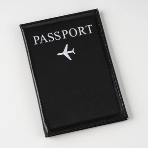 Classic black faux leather passport cover with white plane icon and text on white background