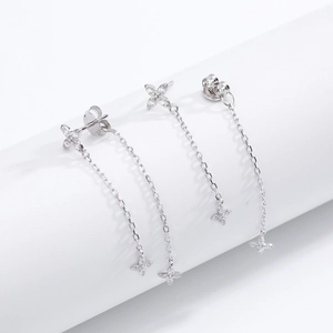Detail of silver flower tassel earrings with sparkling zircon stones and hanging chains