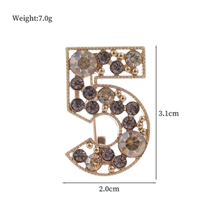 Number 5 gold brooch with colorful rhinestones measuring 3.1cm in height and 2.0cm width