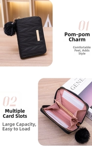 Detail of black quilted leather wallet showing card slots and fluffy pom-pom charm