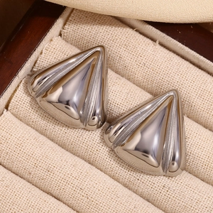 Close-up of silver geometric triangular petal earrings with 3D stripe texture details
