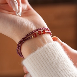 Double-layer garnet beaded bracelet with red agate accents on female wrist