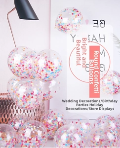 Close-up of clear party balloons filled with colorful round confetti for celebrations