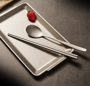 Detail of vintage snowflake grey stainless steel cutlery set with a spoon and chopsticks