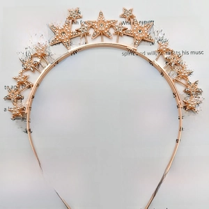 Rose gold headband featuring sparkling rhinestone stars and faux pearls for festive parties