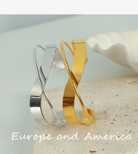 Minimalist gold and silver geometric irregular wrap open bangles on stone
