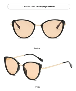 Detail view of cat eye sunglasses with black gold frames and champagne lenses