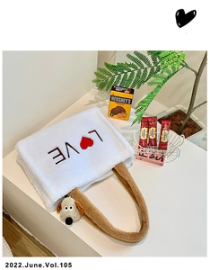 Detail showing white faux fur tote bag with LOVE embroidery and cute dog plush pendant