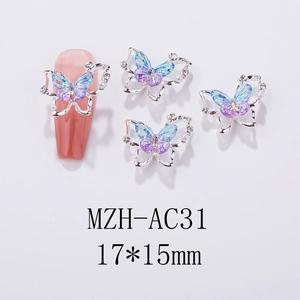 Macro detail of aurora butterfly nail charm with pearls on a pink coffin nail tip