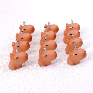 Detailed arrangement of eleven brown resin capybara charms with metal rings for DIY crafts