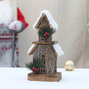 Close-up of wooden Christmas cabin with faux snow roof and pine cone berry accents