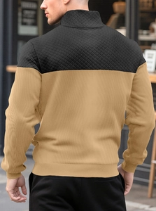 Detailed back view of a men's zip sweatshirt featuring black and khaki diamond texture
