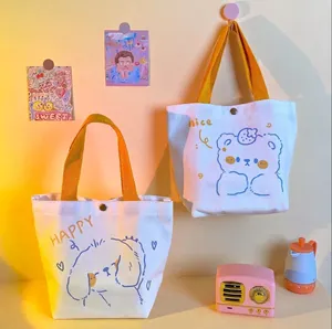 Cute cartoon canvas tote bag with yellow handles featuring bear and dog illustrations