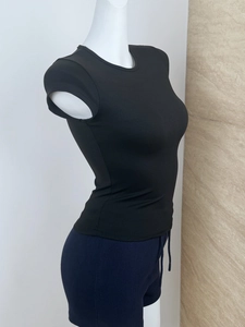Detail of black slim fit athletic t-shirt with elastic cap sleeves on a mannequin