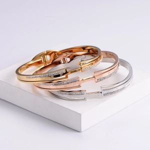 Detail of Roman numeral stack bracelets in gold, rose gold, and silver finishes