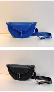 Detail of blue and black pebbled leather half-moon crossbody bags with wide straps