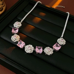 Detail of pink crystal necklace with rose settings and diamond-paved silver chain