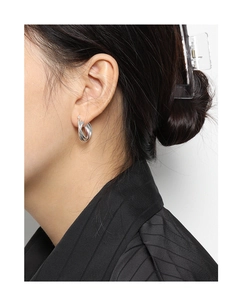 Detailed view of silver multi-layer layered S925 sterling silver hoop earrings on model