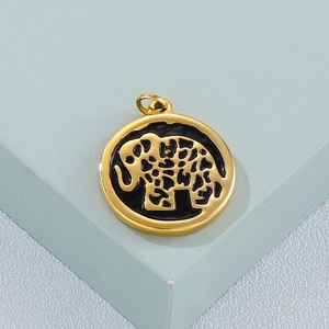 Macro shot of gold stainless steel round pendant featuring a hollow elephant design
