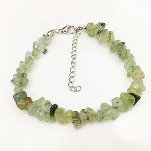 Macro detail of natural light green gemstone chips bracelet with silver lobster clasp